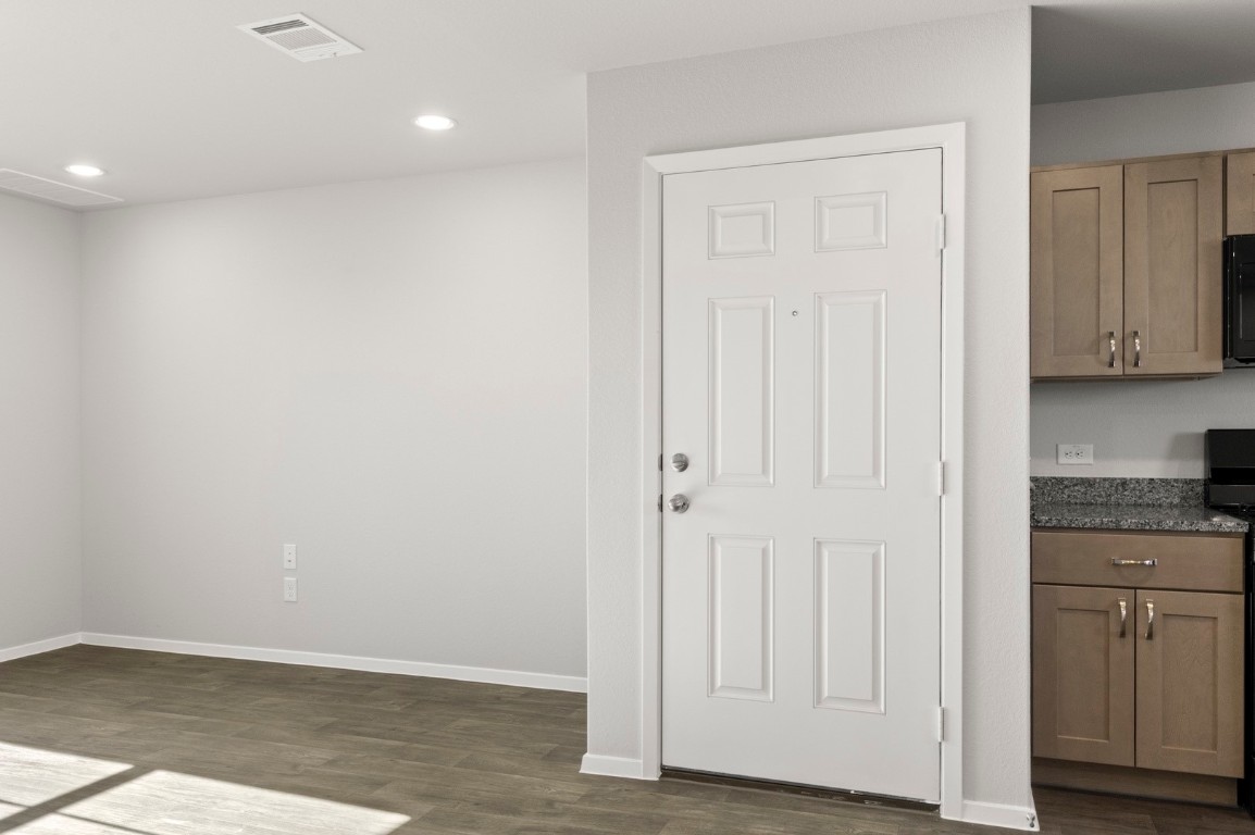 123 Daylily Drive Elgin, TX 78621 - Photo 7 of 33 a view of cabinets with wooden floor
