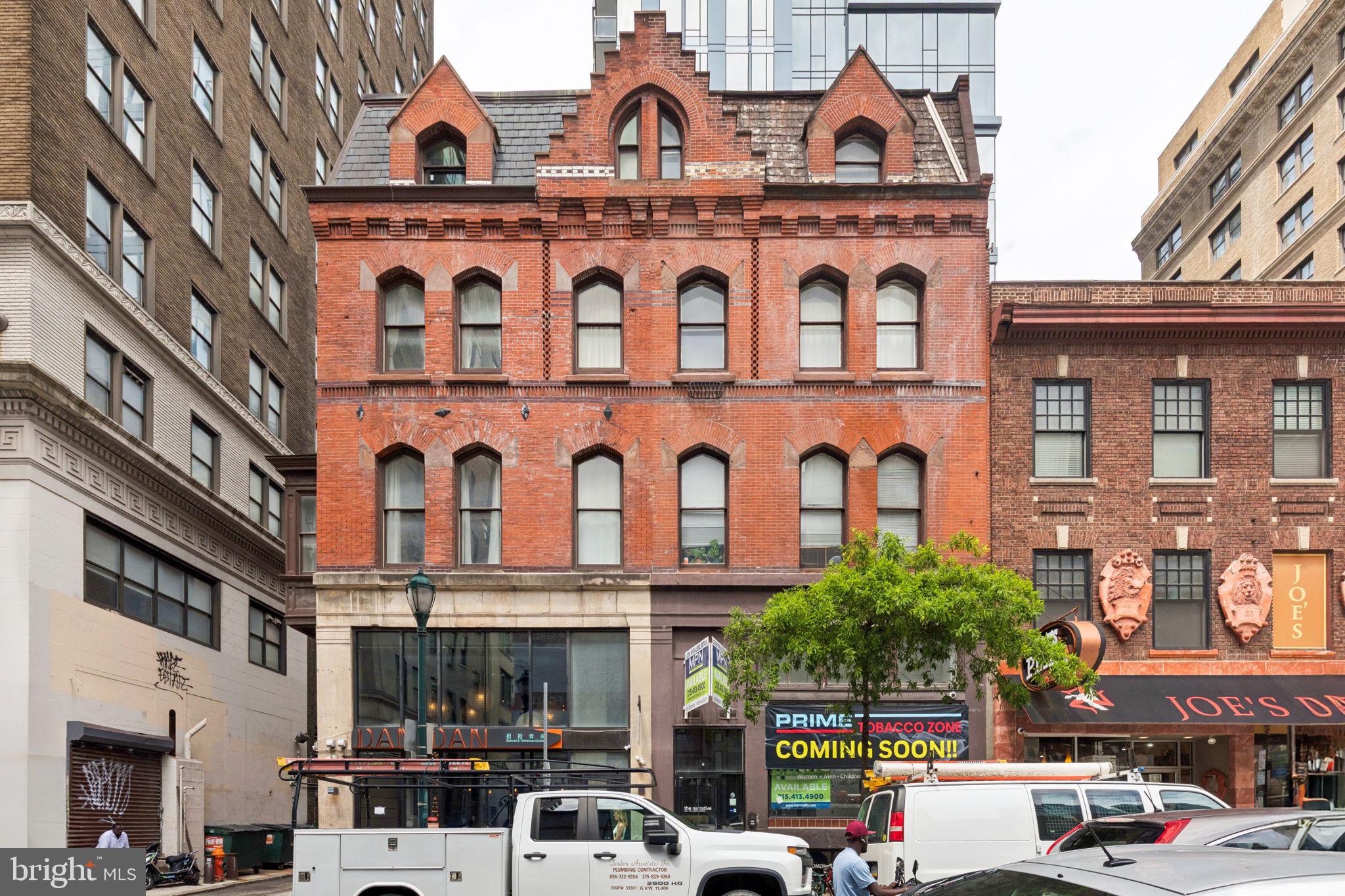 126 South 16th Street, Unit 3F Philadelphia, PA 19102 - Photo 10 of 11 a front view of a building with cars parked