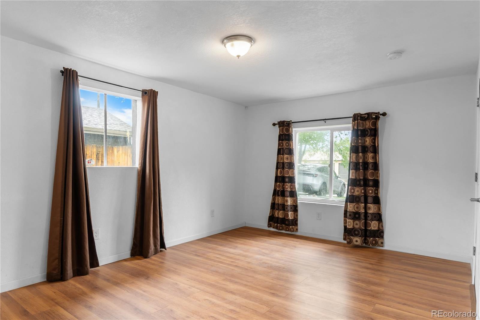 7010 West 44th Avenue Wheat Ridge, CO 80033 - Photo 16 of 31 wooden floor in an empty room with a window