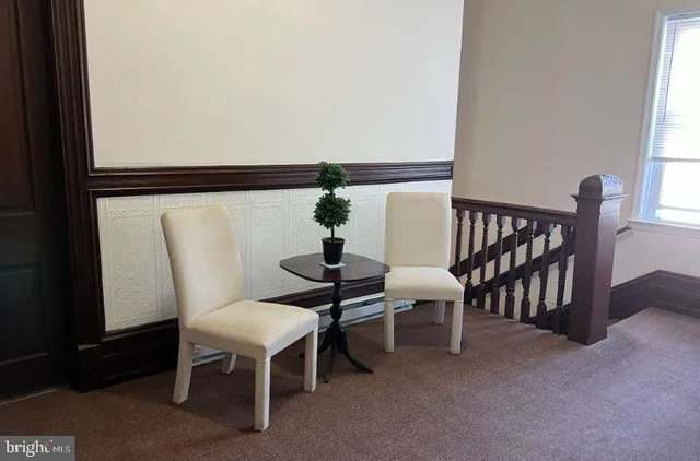 a view of a room with furniture and windows