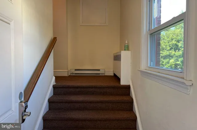 a view of entryway with wooden floor and a front door