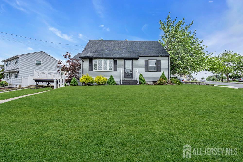 a view of a house with a big yard and potted plants