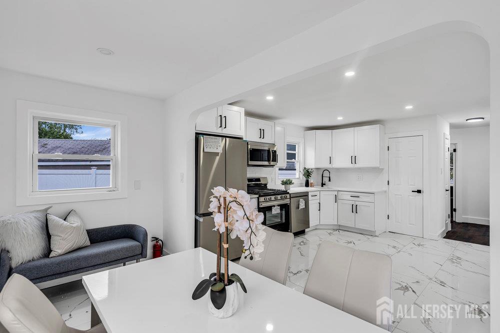 99 Crestview Road Fords, NJ 08863 - Photo 11 of 36 a kitchen with stainless steel appliances kitchen island granite countertop a refrigerator and a stove top oven