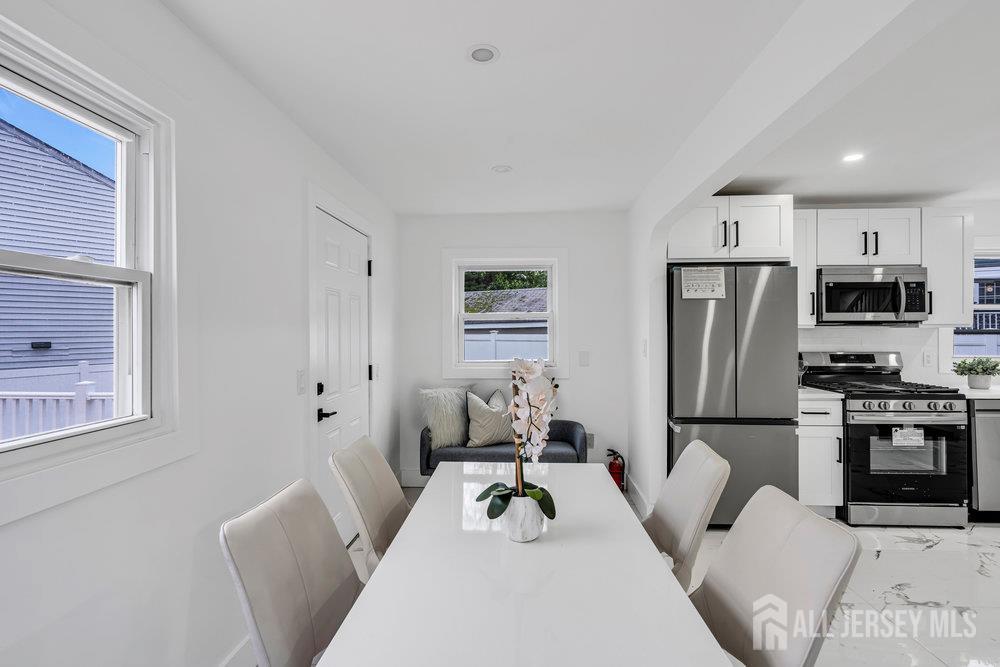 99 Crestview Road Fords, NJ 08863 - Photo 12 of 36 a living room with furniture a refrigerator and a fireplace