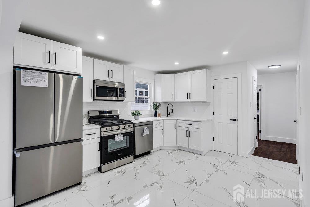 99 Crestview Road Fords, NJ 08863 - Photo 14 of 36 a kitchen with a refrigerator sink and microwave