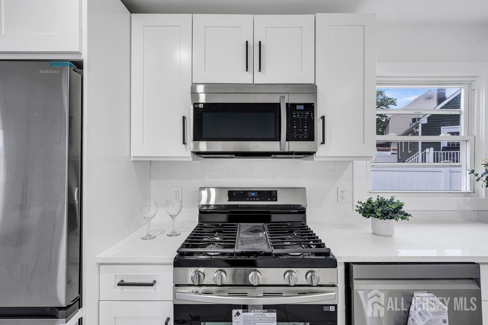 99 Crestview Road Fords, NJ 08863 - Photo 16 of 36 a kitchen with stainless steel appliances granite countertop white cabinets and a stove top oven