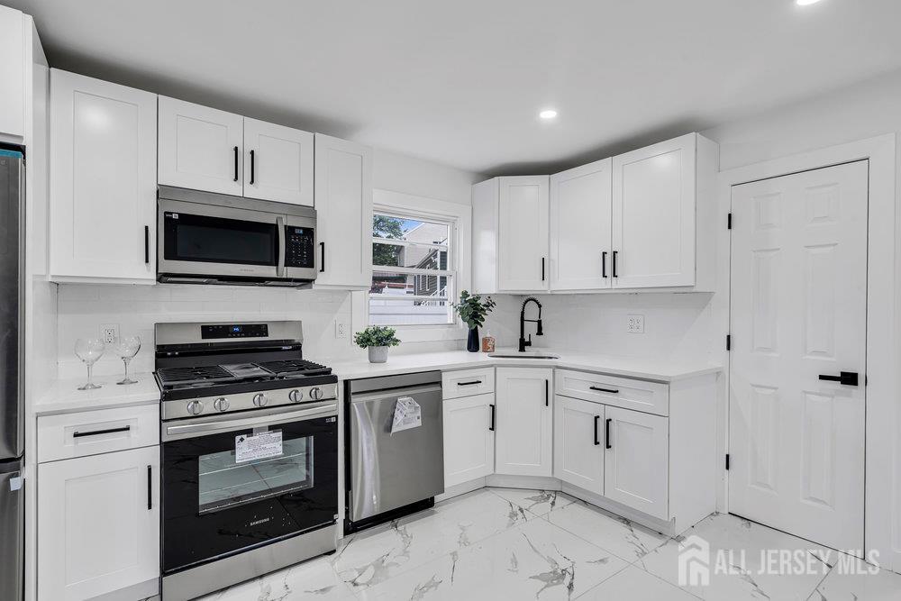99 Crestview Road Fords, NJ 08863 - Photo 17 of 36 a kitchen with cabinets stainless steel appliances and a counter space