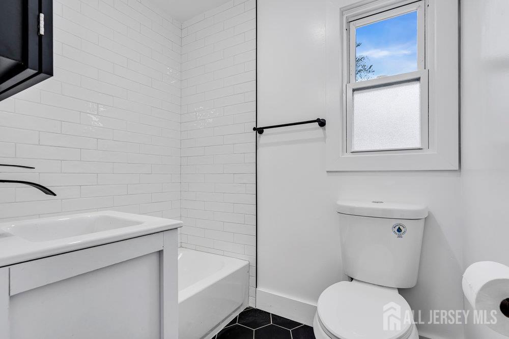 99 Crestview Road Fords, NJ 08863 - Photo 18 of 36 a bathroom with a toilet sink and mirror