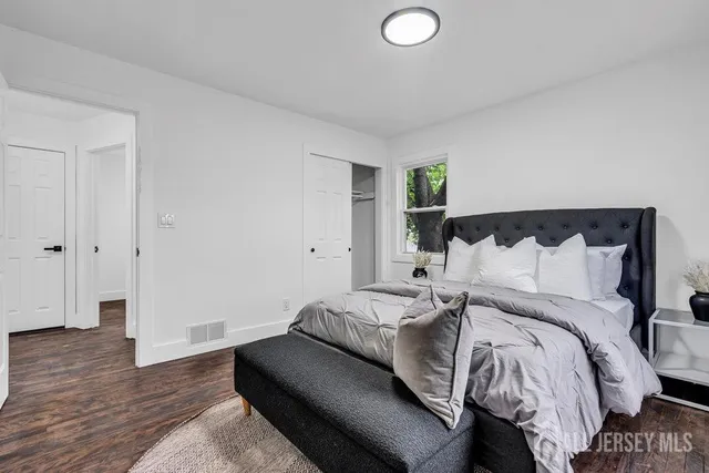 a bed room with a bed and a lamp