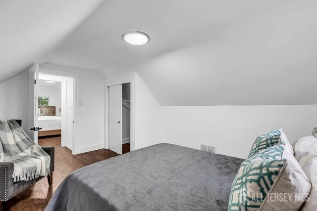 a bedroom with a bed and a chair