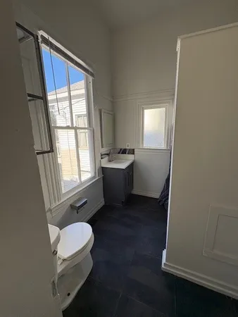 a room with a window and wooden floor