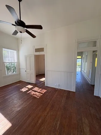 a view of empty room with wooden floor