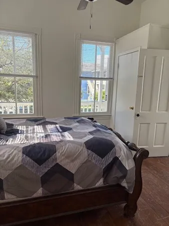 a bed sitting in a bedroom next to a window