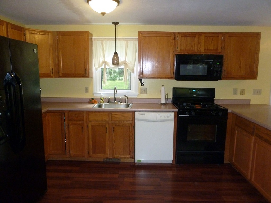 80 Edgewater Road Mashpee, MA 02649 - Photo 16 of 19 a kitchen with a sink and a refrigerator