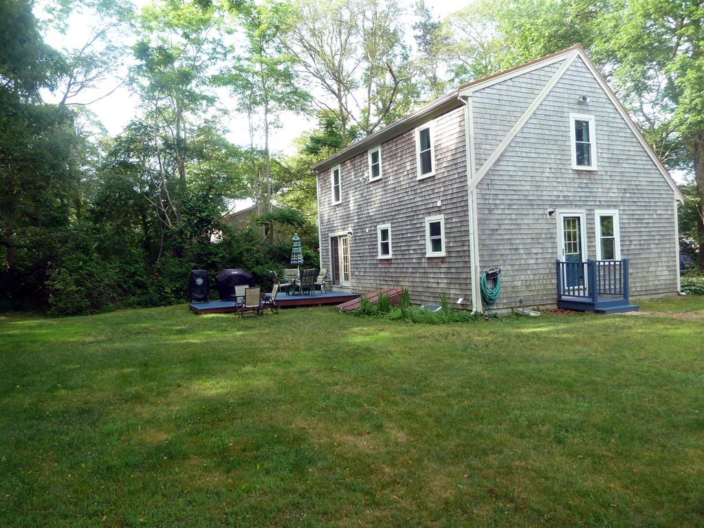 80 Edgewater Road Mashpee, MA 02649 - Photo 3 of 19 a front view of a house with a garden