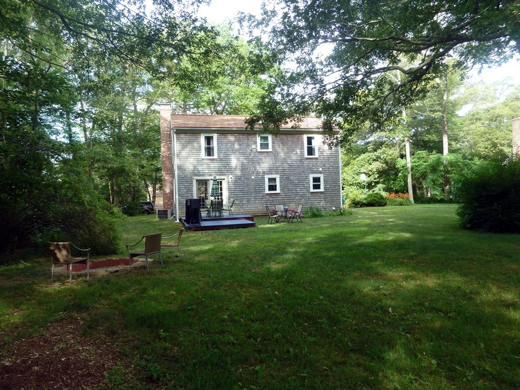 80 Edgewater Road Mashpee, MA 02649 - Photo 4 of 19 a view of a house with backyard sitting area and garden