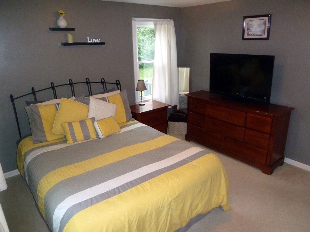 80 Edgewater Road Mashpee, MA 02649 - Photo 5 of 19 a bedroom with a bed and a flat screen tv
