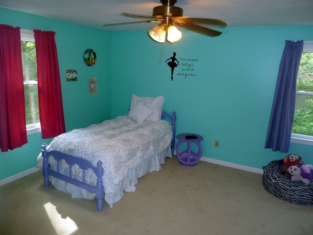 80 Edgewater Road Mashpee, MA 02649 - Photo 8 of 19 a bedroom with a bed and a chandelier