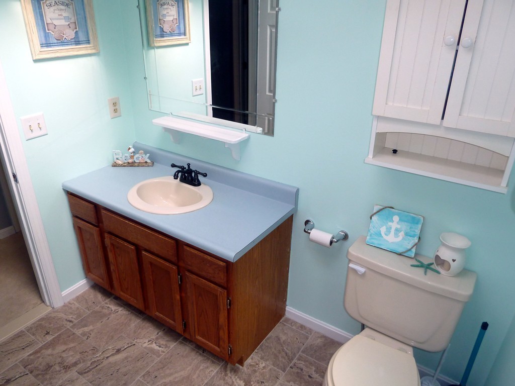 80 Edgewater Road Mashpee, MA 02649 - Photo 9 of 19 a bathroom with a toilet a sink and a mirror