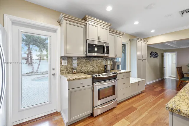 a kitchen with stainless steel appliances granite countertop a stove and a sink