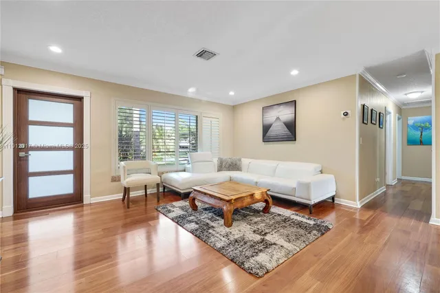 a living room with furniture and wooden floor