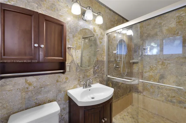 a bathroom with a sink toilet and shower