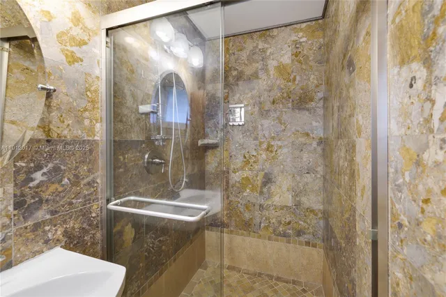 a bathroom with a shower and sink