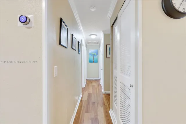 a view of a hallway with wooden floor
