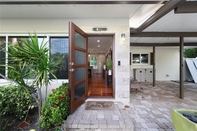 a view of a hallway with potted plants