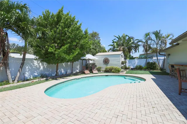 a view of a backyard with plants and a patio