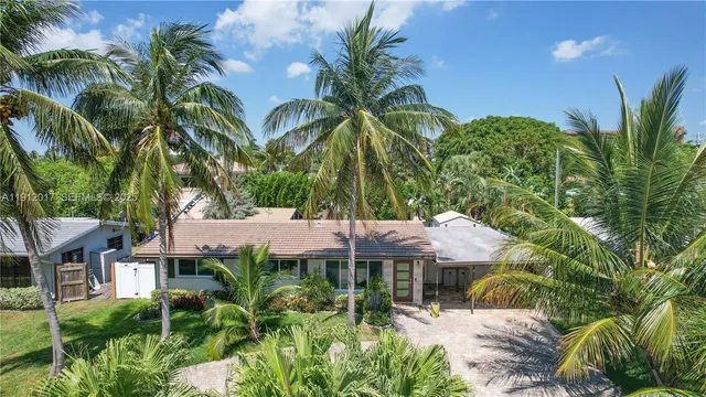 a view of a house with a tree in front