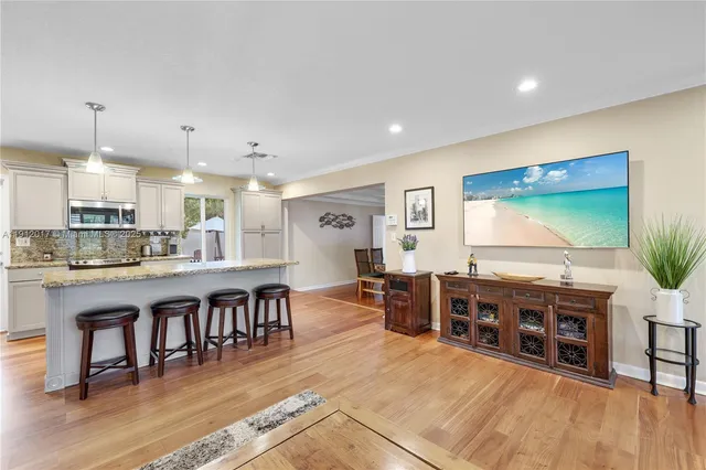 a large kitchen with lots of counter space and furniture