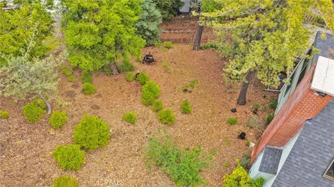 an aerial view of a houses with a lake