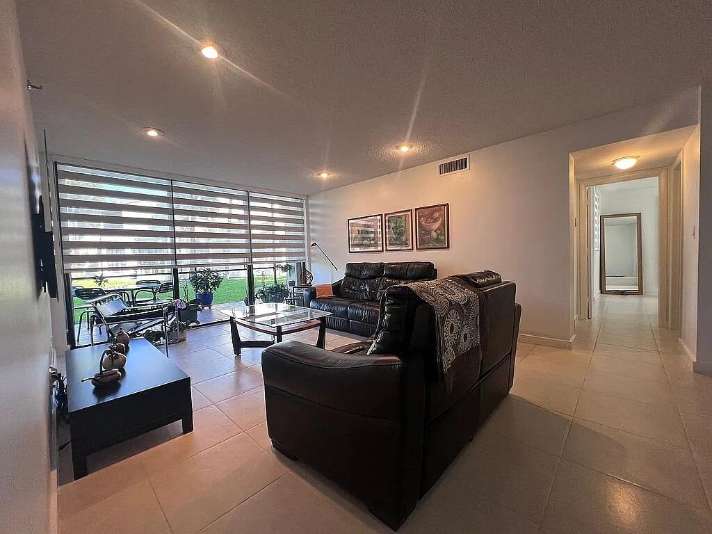 6463 La Costa Drive, Unit 105 Boca Raton, FL 33433 - Photo 11 of 40 a living room with furniture and large windows
