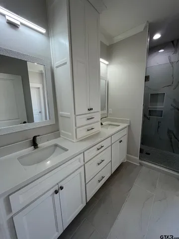 a bathroom with double sink and a mirror