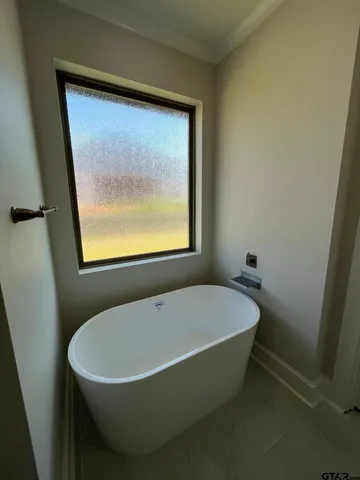 a white bath tub sitting in a bathroom