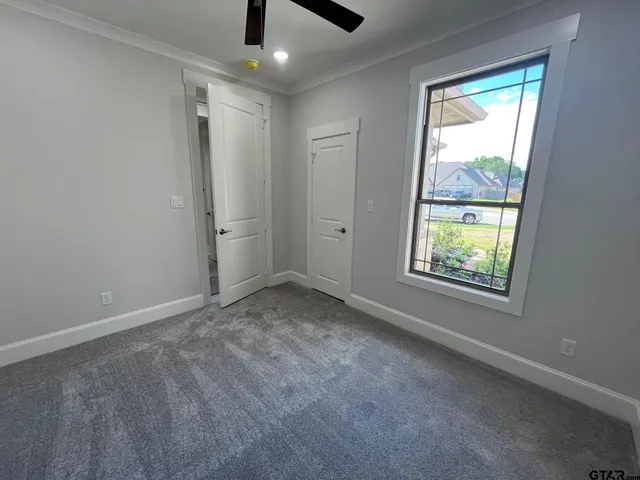 an empty room with windows and closet
