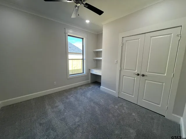 an empty room with windows and closet