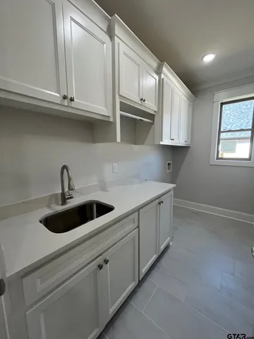 a kitchen with stainless steel appliances granite countertop white cabinets a sink and dishwasher