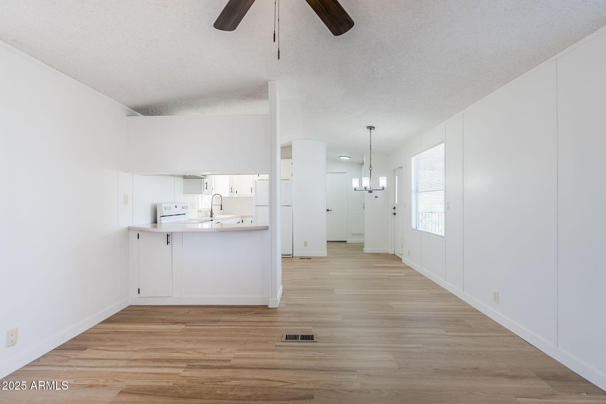 152 Scott Circle Tonto Basin, AZ 85553 - Photo 11 of 51 a view of kitchen and empty room with wooden floor