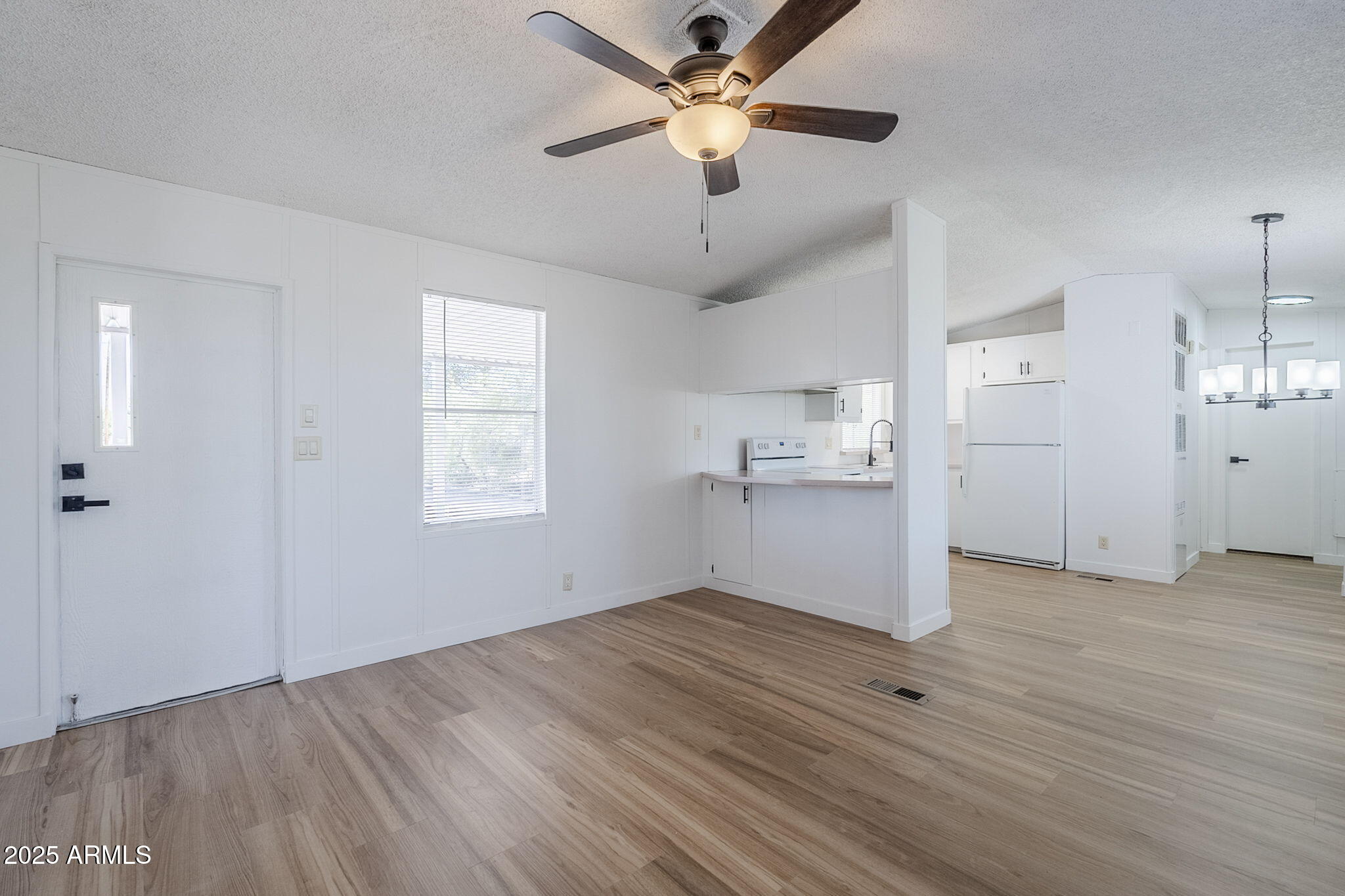 152 Scott Circle Tonto Basin, AZ 85553 - Photo 12 of 51 a view of empty room with wooden floor and ceiling fan