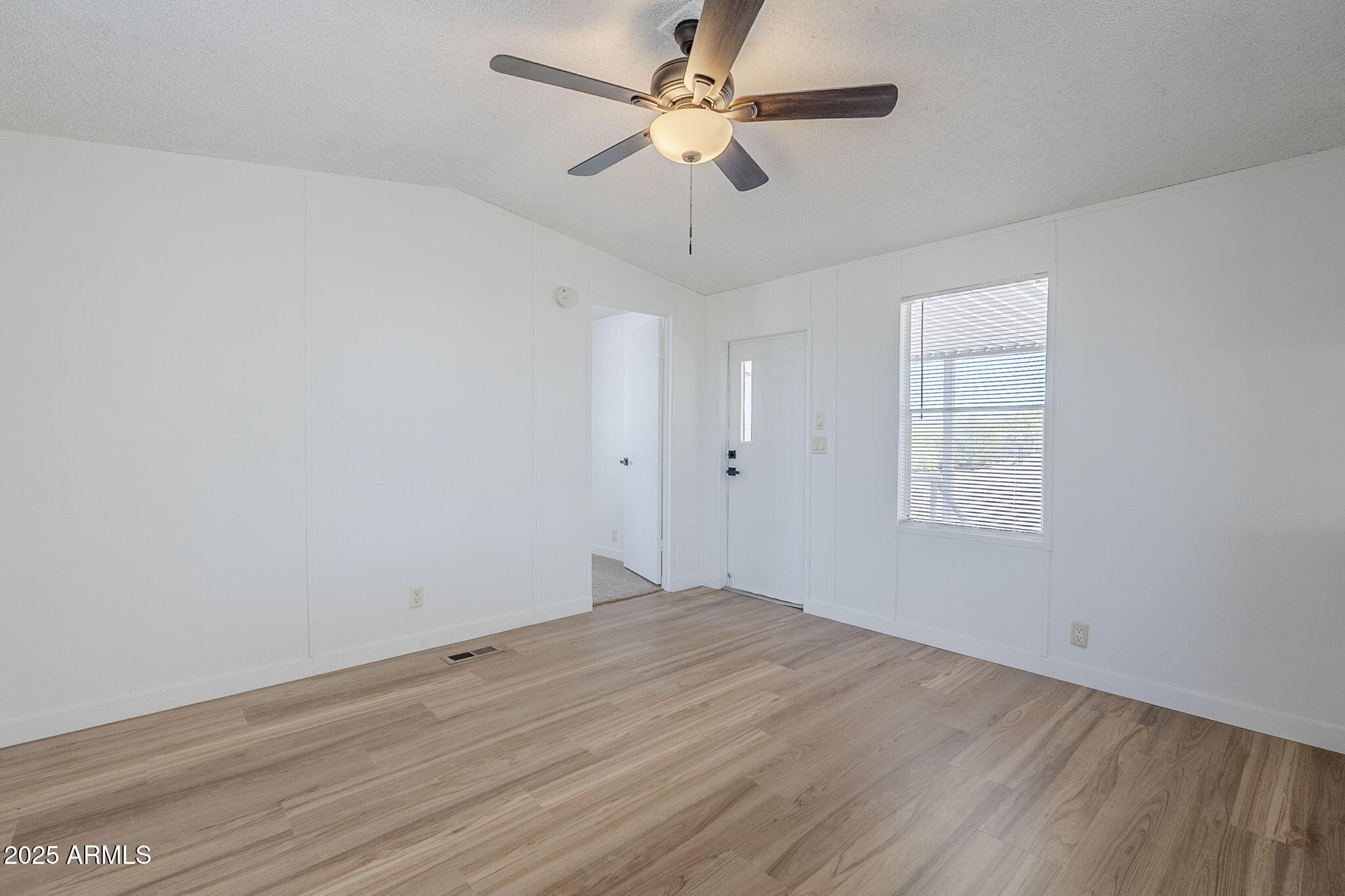 152 Scott Circle Tonto Basin, AZ 85553 - Photo 13 of 51 wooden floor in an empty room with a window