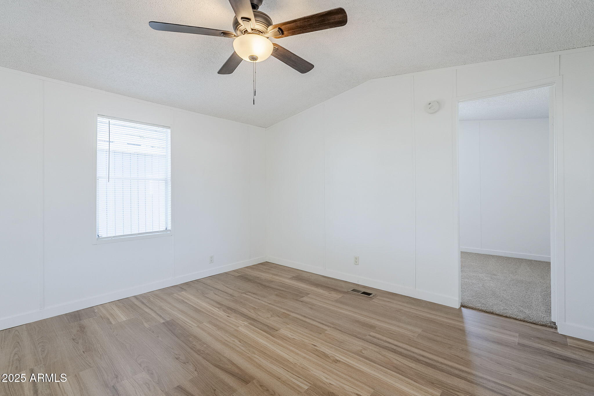 152 Scott Circle Tonto Basin, AZ 85553 - Photo 14 of 51 wooden floor in an empty room with a window