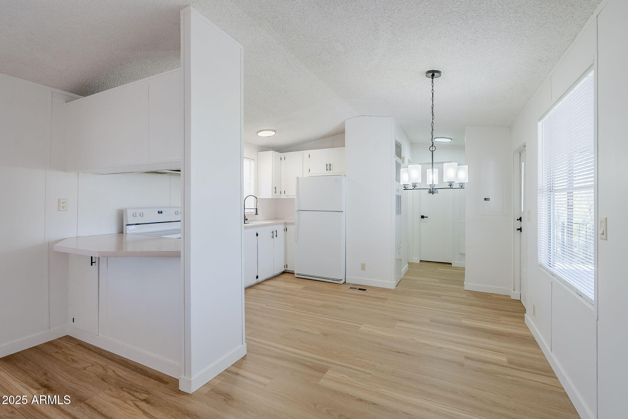 152 Scott Circle Tonto Basin, AZ 85553 - Photo 16 of 51 a view of a kitchen with white cabinets and wooden floor