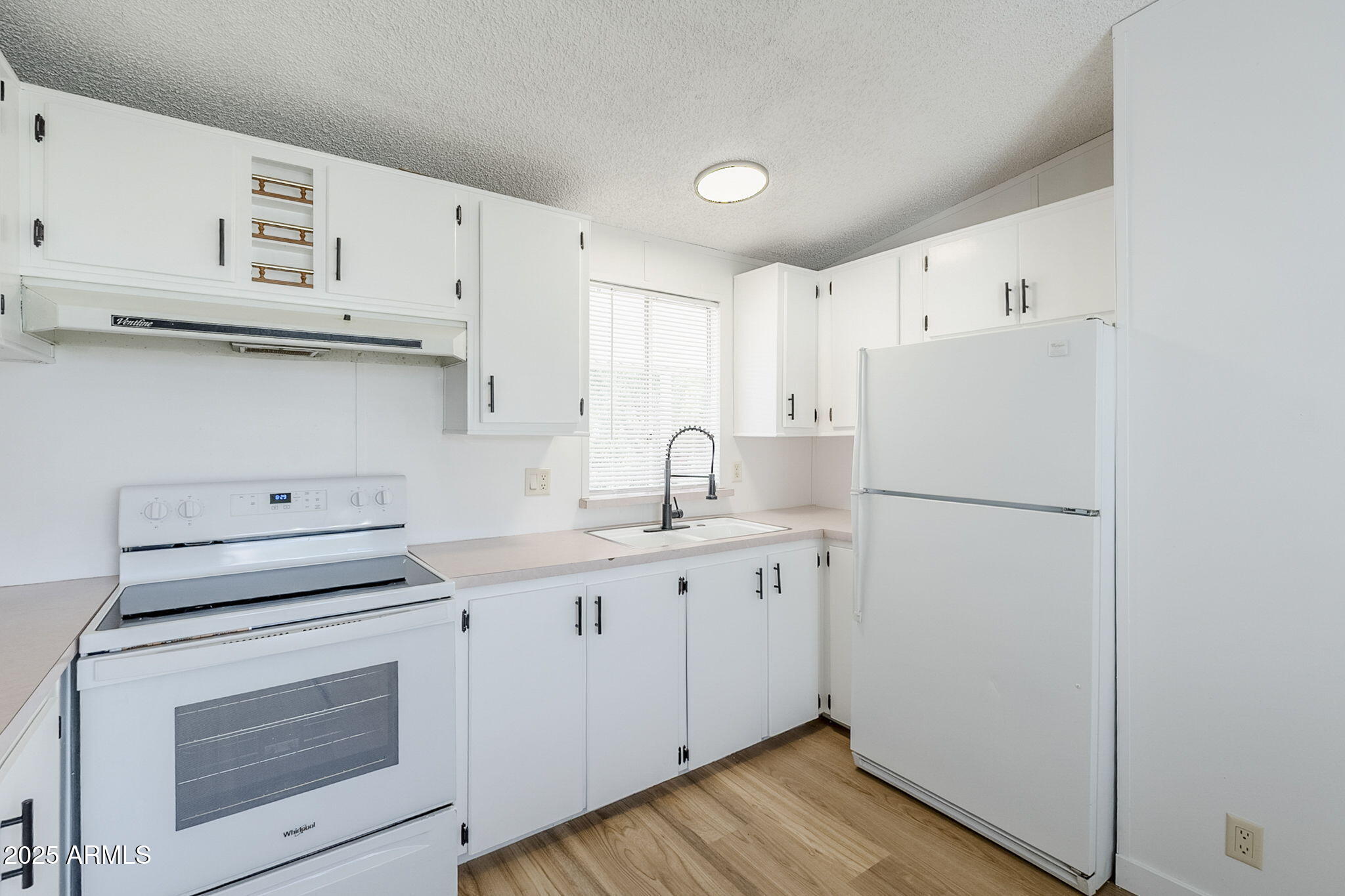 152 Scott Circle Tonto Basin, AZ 85553 - Photo 18 of 51 a kitchen with cabinets appliances a sink and a counter space