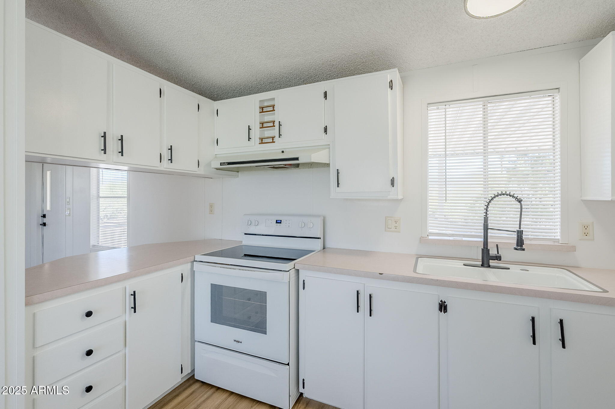 152 Scott Circle Tonto Basin, AZ 85553 - Photo 19 of 51 a kitchen with white cabinets and white appliances
