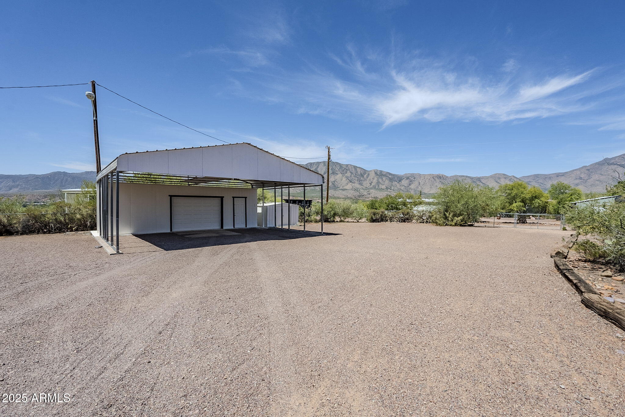 152 Scott Circle Tonto Basin, AZ 85553 - Photo 3 of 51 a view of a house with a yard and a large parking space