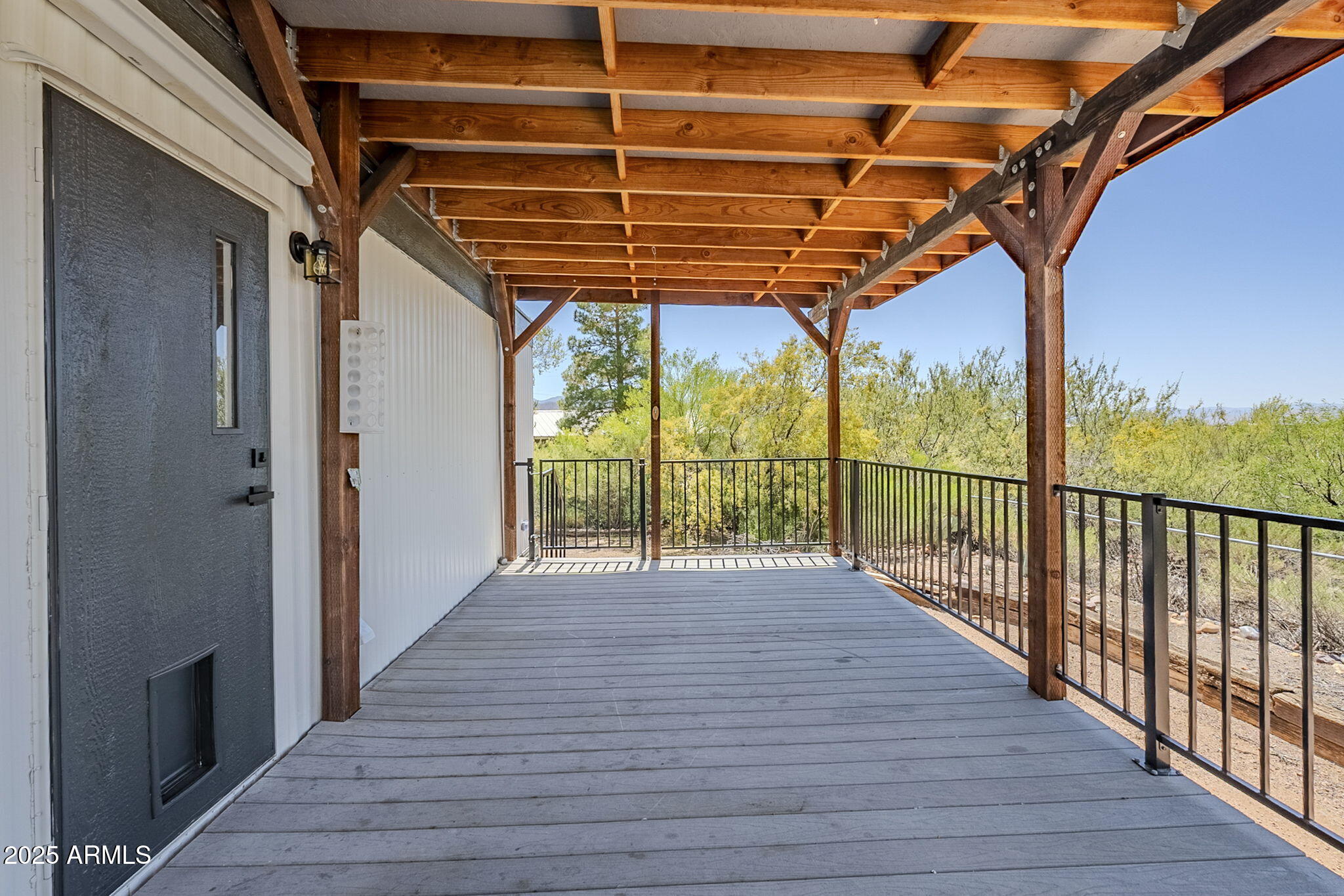 152 Scott Circle Tonto Basin, AZ 85553 - Photo 33 of 51 a view of porch with wooden floor and iron stairs
