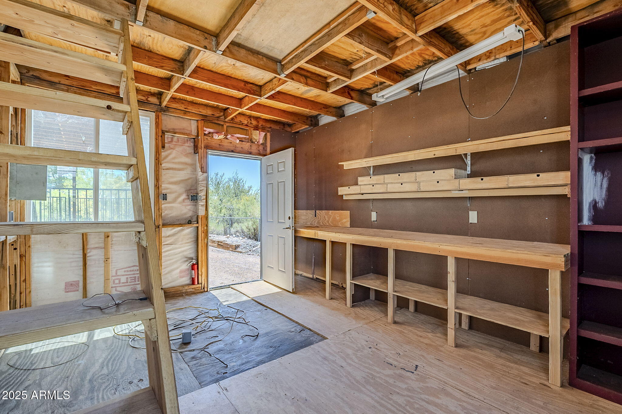 152 Scott Circle Tonto Basin, AZ 85553 - Photo 40 of 51 a view of an empty room with wooden floor and windows