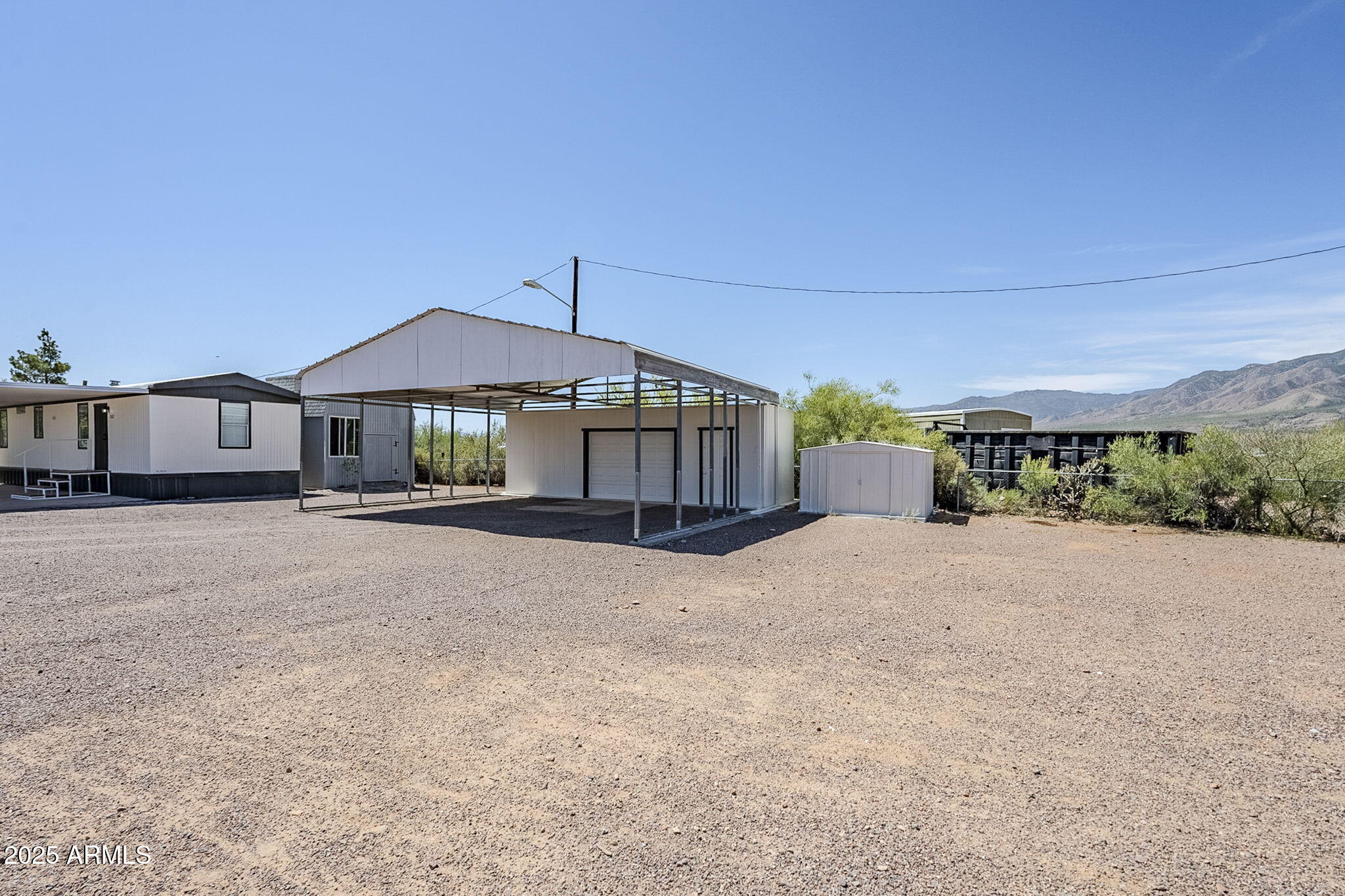 152 Scott Circle Tonto Basin, AZ 85553 - Photo 5 of 51 a patio with a table and chairs under an umbrella